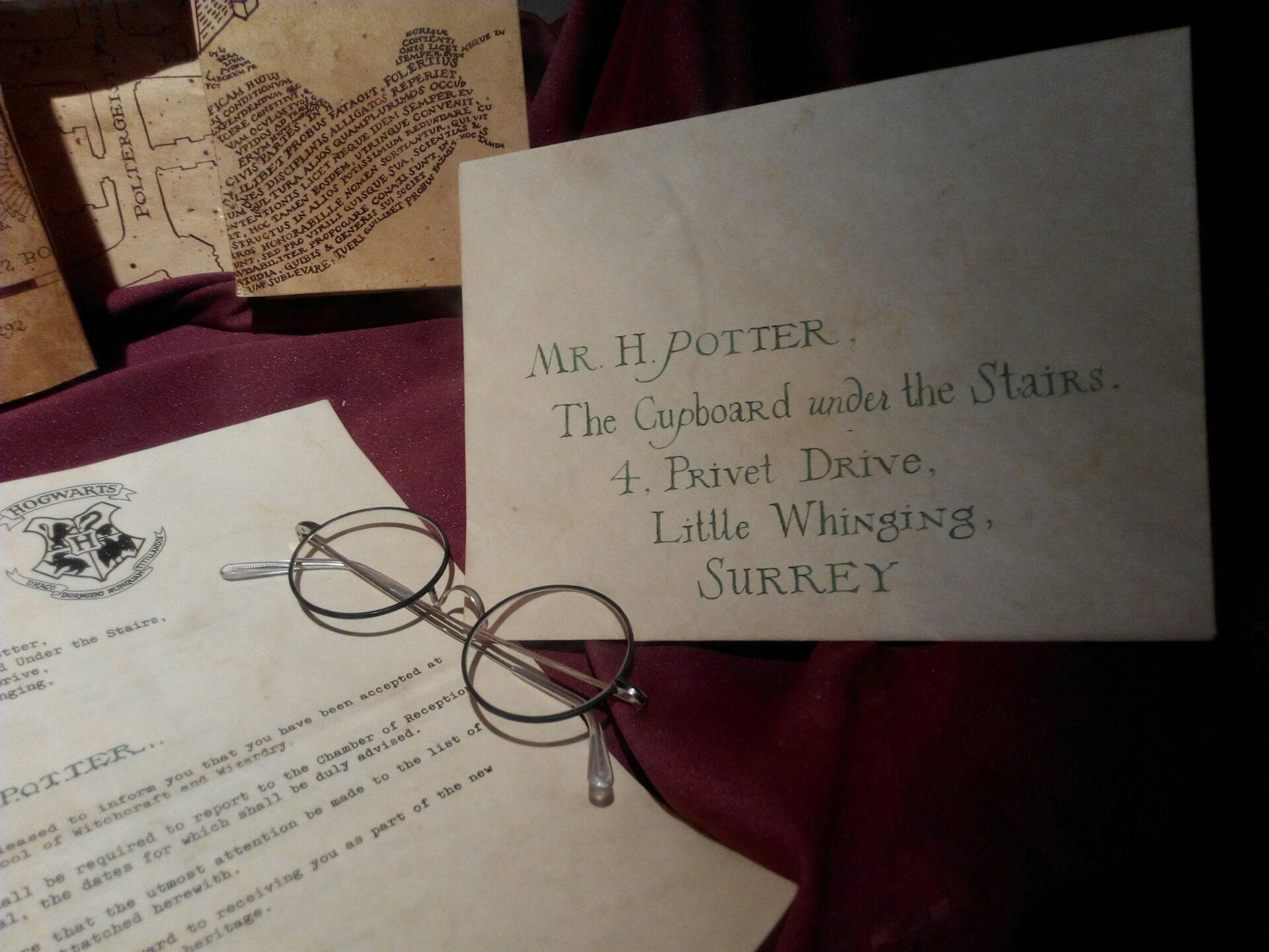 letter addressed to harry potter with round glasses on a table